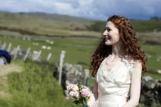 This Scottish bride looks perfect with her untamed curls amidst the backdrop