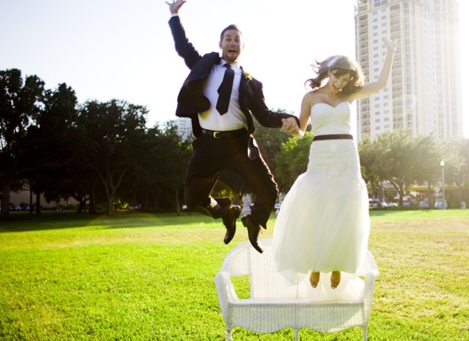 stylish bride and groom jumping