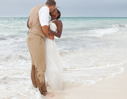 destination wedding, bride and groom kissing in the sea
