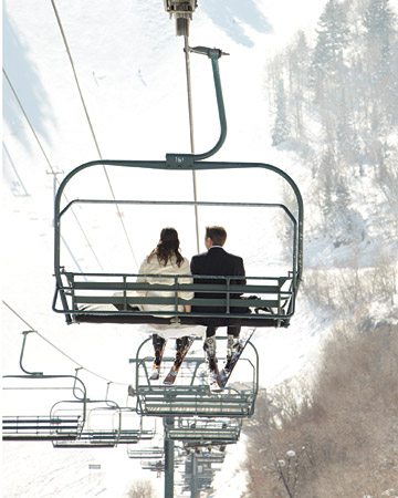 bride and groom on ski lift winter wedding