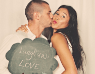 bride and groom in photobooth with chalkboard sign bride and groom in photobooth with chalkboard sign