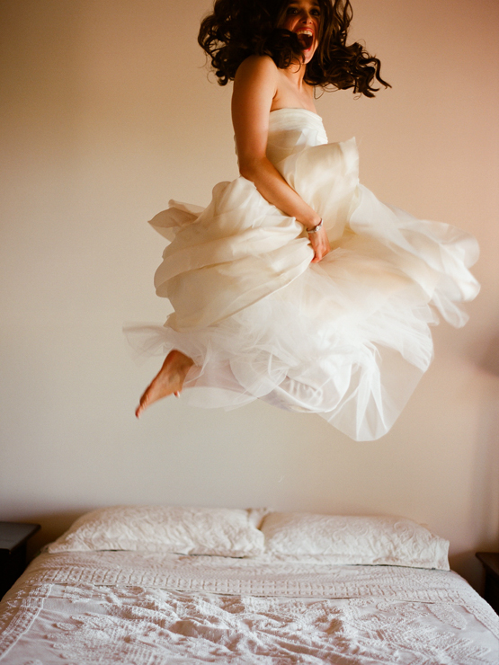 Elizabeth Messina bride jumping on bed
